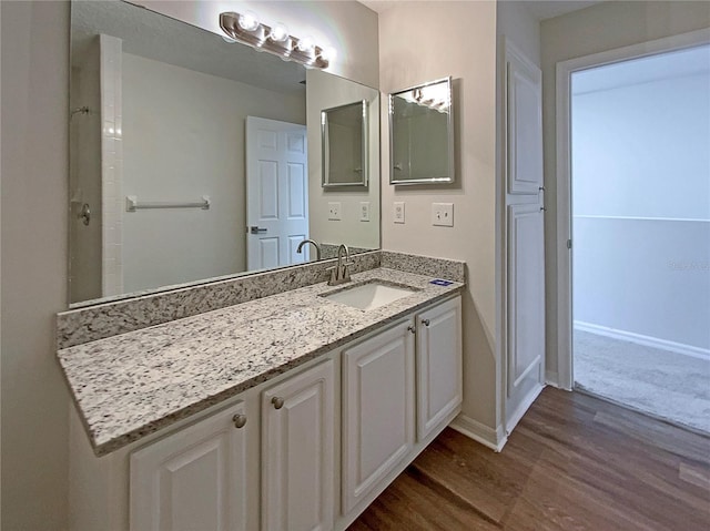 bathroom with vanity and hardwood / wood-style flooring