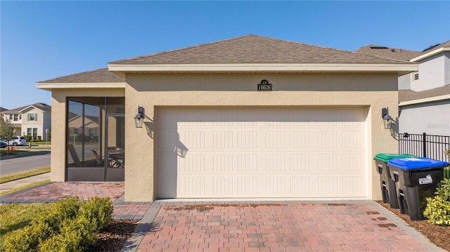 view of front of house with a garage and a sunroom