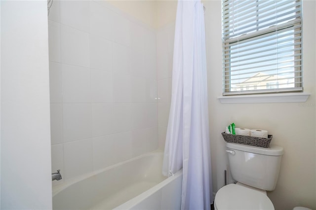 bathroom with toilet and shower / bath combo with shower curtain