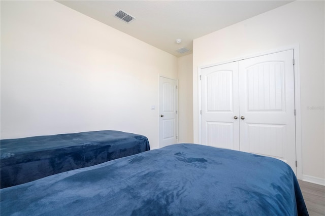 bedroom featuring wood-type flooring and a closet