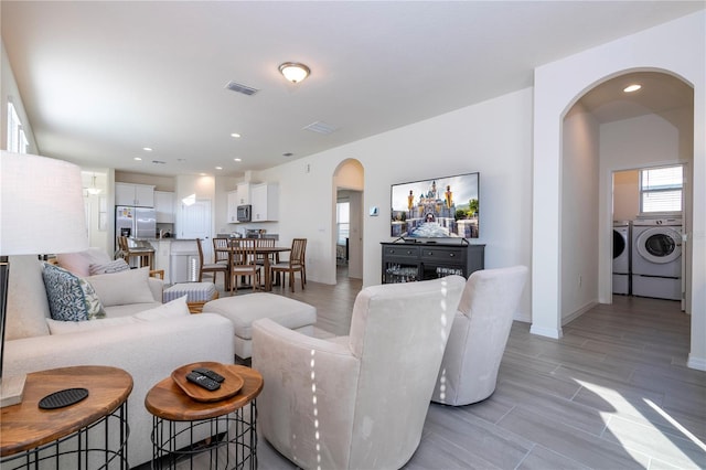 living room with washer and clothes dryer