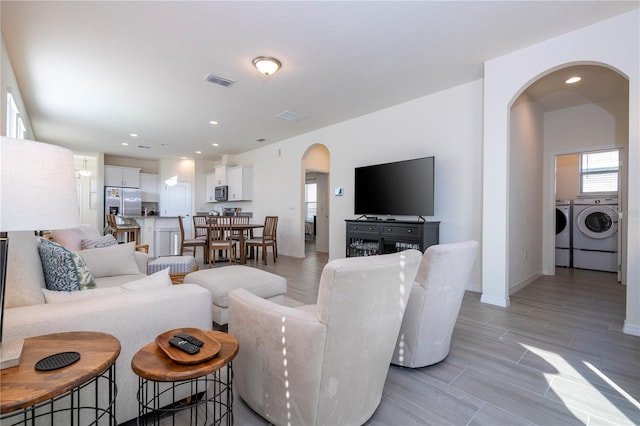 living room featuring washing machine and clothes dryer