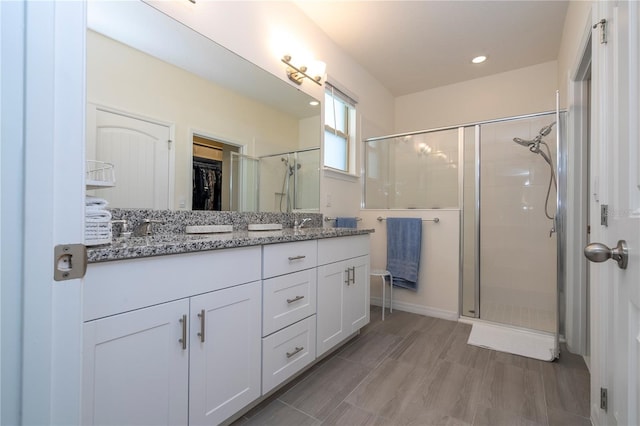 bathroom featuring vanity and a shower with shower door