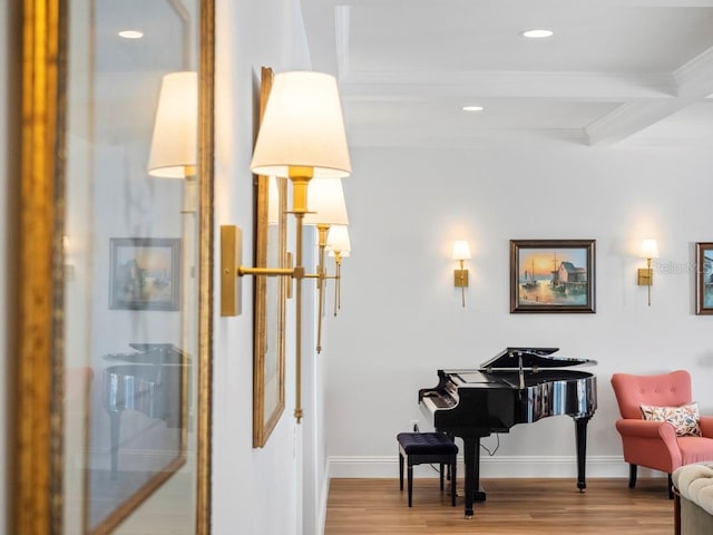 sitting room with light hardwood / wood-style floors, ornamental molding, beam ceiling, and coffered ceiling