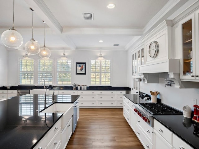 kitchen with pendant lighting, white cabinetry, and beamed ceiling