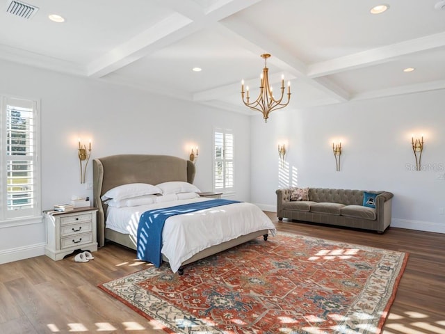 bedroom featuring beam ceiling, wood-type flooring, and multiple windows