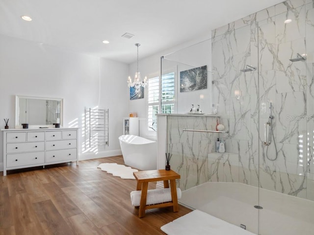 bathroom with vanity, a notable chandelier, plus walk in shower, and hardwood / wood-style flooring