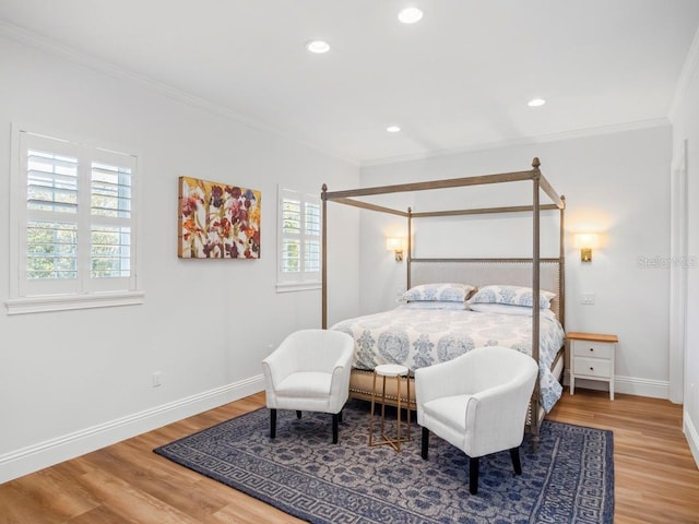 bedroom with ornamental molding and hardwood / wood-style flooring