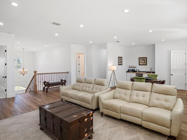 living room featuring light wood-type flooring and a chandelier