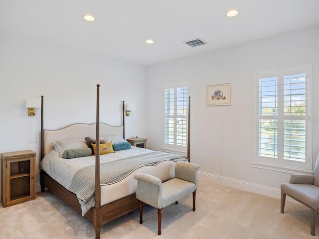 carpeted bedroom with multiple windows