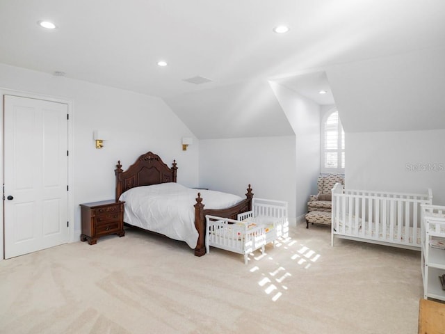 carpeted bedroom with lofted ceiling