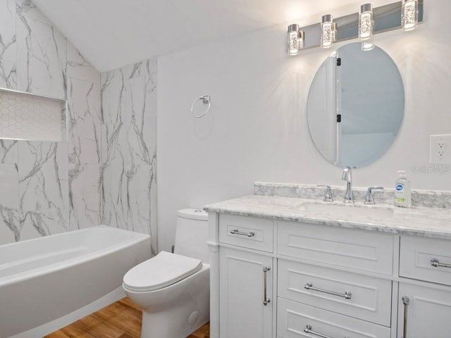 full bathroom with toilet, tiled shower / bath combo, hardwood / wood-style flooring, lofted ceiling, and vanity