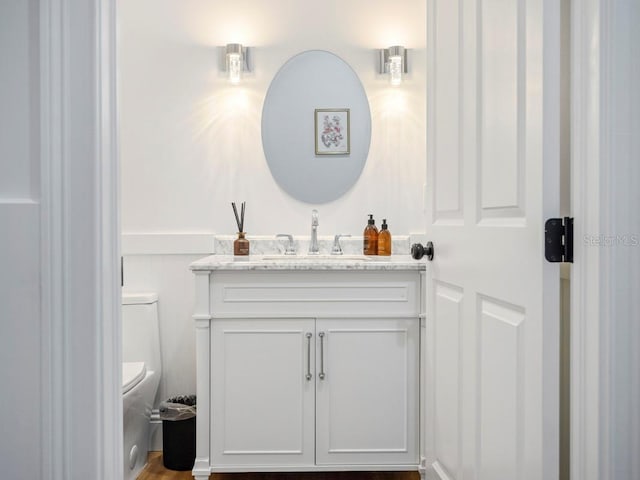 bathroom with toilet and vanity