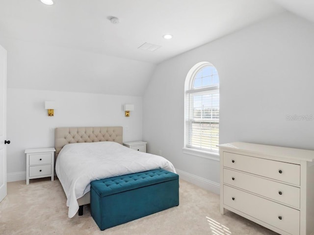 carpeted bedroom with lofted ceiling