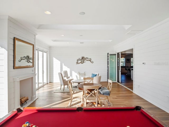 recreation room featuring wood-type flooring, billiards, ornamental molding, and wooden walls