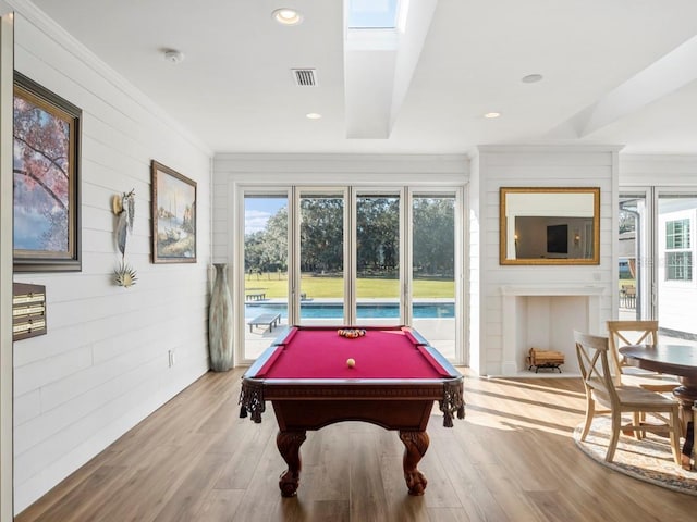 playroom with a skylight, crown molding, pool table, and wood-type flooring