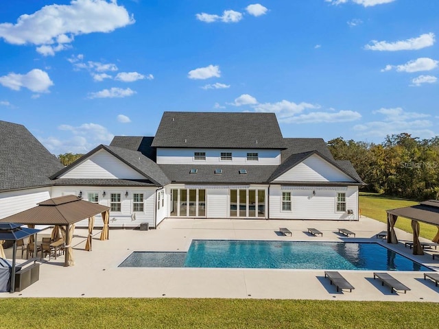 rear view of house featuring a gazebo and a patio