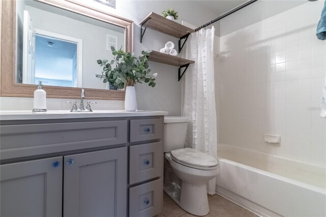 full bathroom featuring tile patterned flooring, vanity, shower / bath combo with shower curtain, and toilet