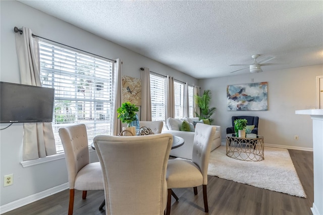 dining room with a textured ceiling, wood finished floors, ceiling fan, and baseboards