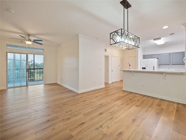 unfurnished living room with light wood-type flooring, ceiling fan, and crown molding