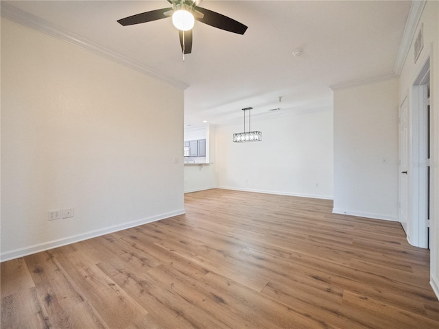 unfurnished room featuring ceiling fan, ornamental molding, and light hardwood / wood-style flooring