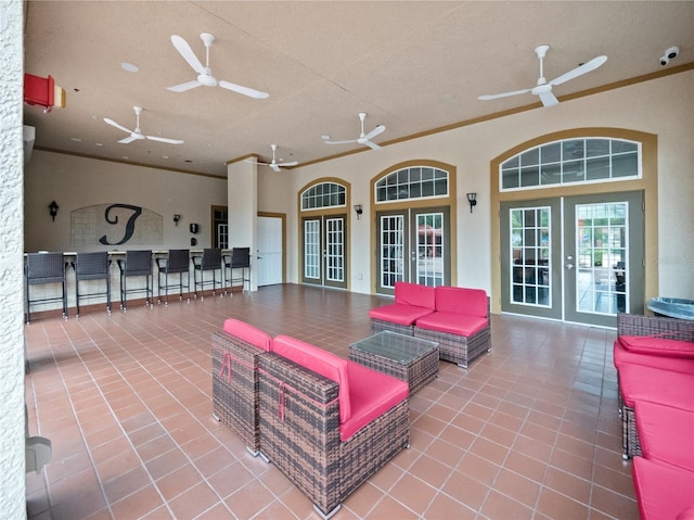 view of patio with ceiling fan, an outdoor bar, an outdoor living space, and french doors