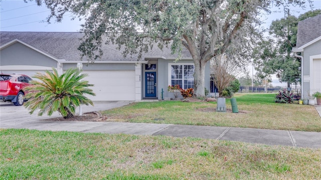 ranch-style home with a garage and a front lawn