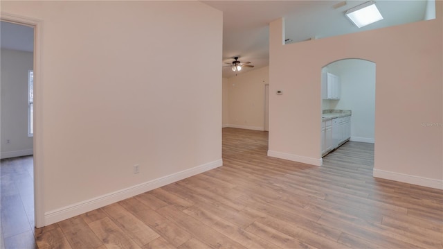 empty room with light wood-type flooring and ceiling fan