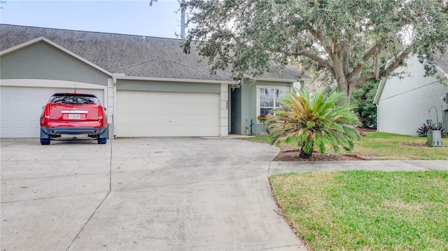 single story home with a front yard and a garage