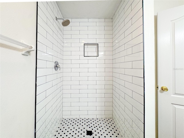 bathroom with a tile shower