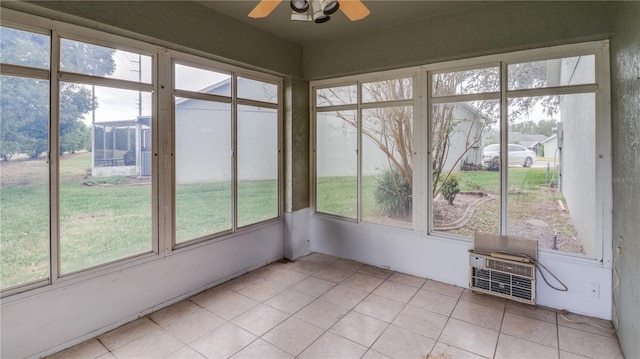 unfurnished sunroom featuring ceiling fan and a healthy amount of sunlight