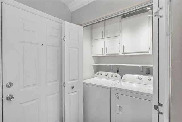 washroom with cabinet space and washing machine and clothes dryer