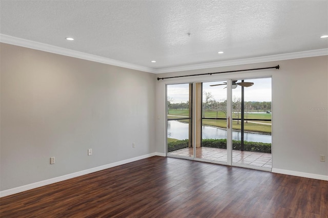 unfurnished room featuring ornamental molding, a water view, wood finished floors, and baseboards