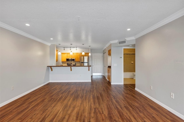 unfurnished living room featuring dark wood-type flooring, visible vents, crown molding, and baseboards