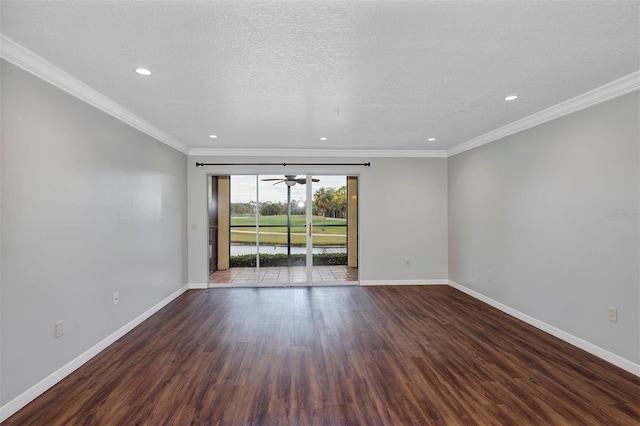 empty room with a textured ceiling, baseboards, wood finished floors, and ornamental molding