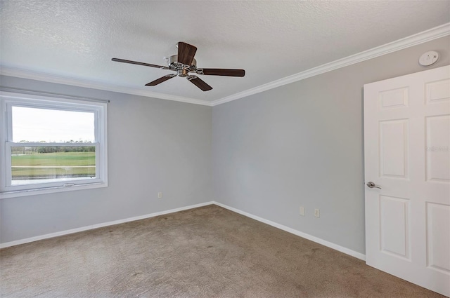 carpeted spare room featuring crown molding, a textured ceiling, baseboards, and ceiling fan