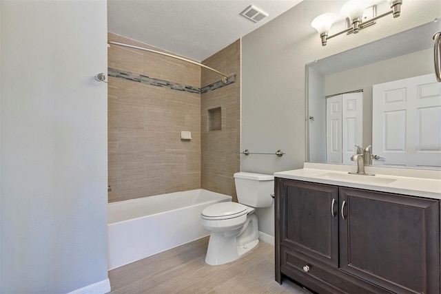 full bathroom with toilet, visible vents, vanity, baseboards, and tub / shower combination