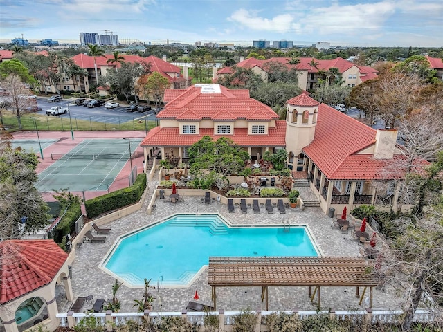 community pool featuring fence and a patio