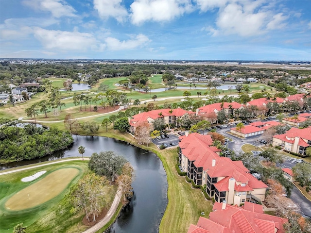 birds eye view of property featuring view of golf course and a water view