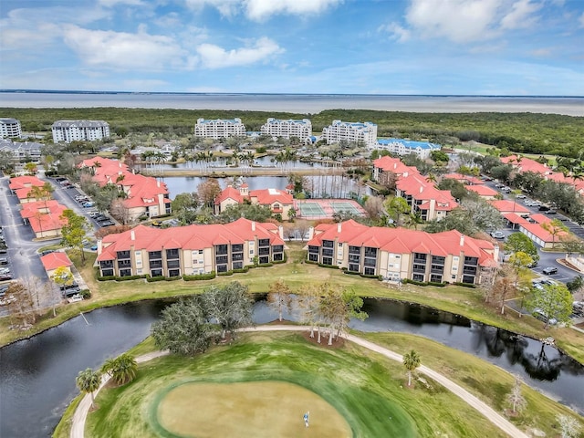 birds eye view of property featuring view of golf course and a water view