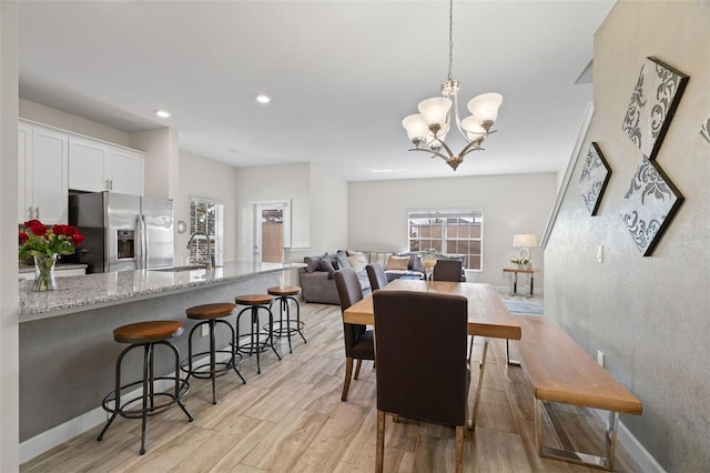 dining area featuring a notable chandelier and sink