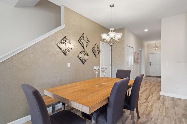 dining space with wood-type flooring and a notable chandelier