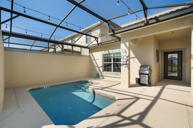 view of pool featuring a lanai, a patio, and area for grilling