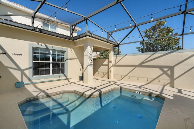 view of pool with a lanai and a patio