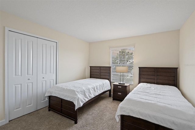 bedroom with light colored carpet and a closet