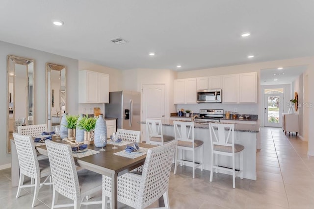 dining area featuring light tile patterned floors