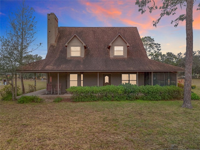 farmhouse-style home featuring a patio area and a lawn