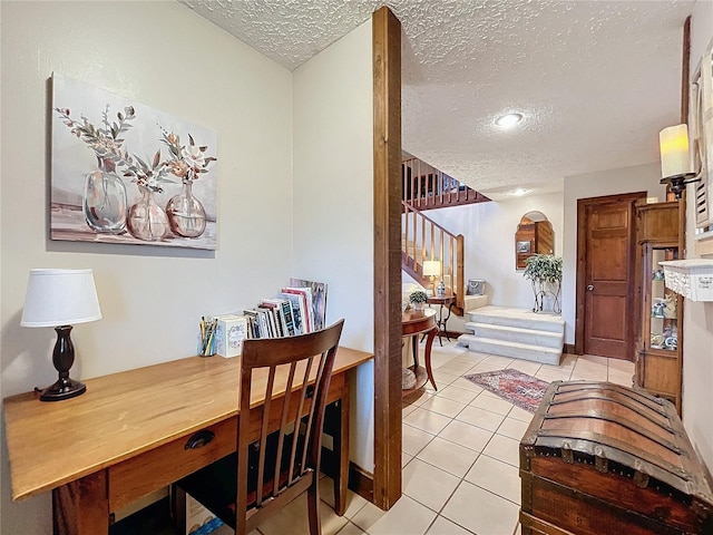 tiled dining room with a textured ceiling