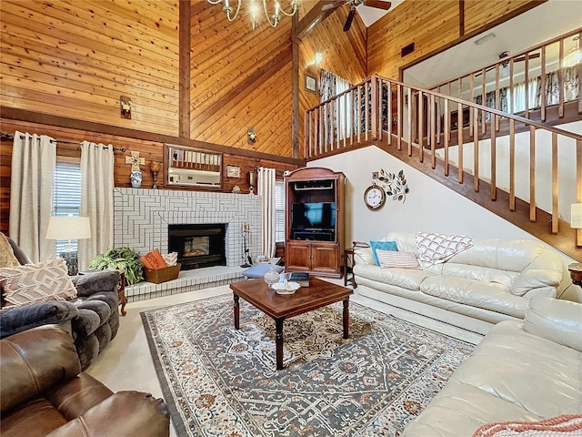 living room featuring high vaulted ceiling, ceiling fan, a brick fireplace, and wooden walls