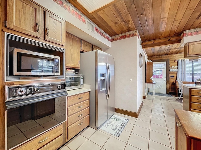 kitchen featuring light tile patterned floors and appliances with stainless steel finishes